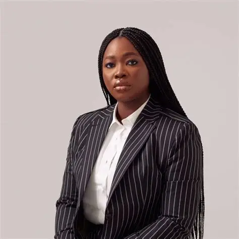 Damilola Olokesusi Biography: Age, Education, Career, Family and Shuttlers Damilola Olokesusi is a Nigerian entrepreneur, technology leader and chemical engineer best known as the co-founder and chief executive officer of Shuttlers. Her company uses technology to provide scheduled shared transportation for professionals and organisations, particularly in major Nigerian cities. Her journey from chemical engineering to technology entrepreneurship began with a simple observation. Lagos commuters faced daily problems with unreliable, uncomfortable and sometimes unsafe public transportation. She eventually turned that problem into a business that connects commuters with scheduled shuttle services. Who Is Damilola Olokesusi? Damilola Olokesusi is a Nigerian entrepreneur and mobility technology executive. She co-founded Shuttlers, a transportation technology company that allows commuters to book seats on scheduled routes through a digital platform. Her work focuses on improving urban mobility through shared transportation. Rather than operating like a conventional ride-hailing service, Shuttlers uses fixed routes and scheduled trips to serve individual commuters and corporate clients. Her career has also included engineering, investment management, entrepreneurship and leadership roles in technology and innovation communities. Damilola Olokesusi Age and Early Life Damilola Olokesusi was born in Lagos, Nigeria, and grew up in Ibadan, Oyo State. Her exact date of birth is not reliably documented in public records, so an exact age should not be stated as fact. She grew up in a family where both of her parents worked with the former National Electric Power Authority, now known as the Power Holding Company of Nigeria. Her early environment followed a more conventional professional path, but her university years exposed her to entrepreneurship and technology. She has described herself as someone who enjoyed mathematics and chemistry from an early age. Those interests influenced her decision to study chemical engineering. Education Olokesusi studied Chemical Engineering at the University of Lagos. Her university experience played an important role in shaping her approach to problem-solving. During a prolonged university strike in 2009, she attended seminars and programmes that introduced her to technology entrepreneurship. That period changed her understanding of career possibilities. Instead of seeing engineering only as a route into the oil and gas industry, she began considering how technology could be used to solve everyday problems. She has also participated in entrepreneurship and leadership programmes, including the Harambeans entrepreneurial network and business education programmes. Early Career After university, Olokesusi gained professional experience through engineering and investment-related roles. She worked as a trainee engineer at Marine Professionals Limited and previously completed an engineering internship at Pan Ocean Oil Corporation. She also gained experience at Asset and Resource Management, where she worked as a management intern. These experiences exposed her to different aspects of engineering, business and corporate operations. She also experimented with entrepreneurship before Shuttlers. One of her early projects involved a fashion technology idea that did not succeed commercially. Rather than abandoning entrepreneurship, she treated the experience as a lesson in developing sustainable business models. How Shuttlers Started The idea for Shuttlers developed from Olokesusi's personal experience with transportation in Lagos. During her working and internship years, she frequently used commercial buses and experienced the difficulty of moving around the city. She also observed that some companies provided staff buses for employees. This raised a question for her: why could smaller companies and individual professionals not have access to a similar scheduled transportation service? The idea became more urgent after one of her sisters experienced a dangerous incident involving a commercial vehicle. The incident highlighted the security concerns that commuters, particularly women, could face while using public transportation. Olokesusi and her co-founders decided to develop a safer and more organised alternative. Founding Shuttlers Shuttlers was founded in 2015 by Olokesusi, Damilola Quadri and Busola Majekodunmi. The company officially launched in October 2016. The business initially operated without a dedicated mobile application. Customers used platforms such as WhatsApp, email and Slack to book rides and receive information about routes and schedules. One of the company's early corporate customers was Andela. This helped demonstrate that there was demand for scheduled transportation designed around the needs of professionals. In 2019, Shuttlers introduced its dedicated mobile application. The platform allowed passengers to book seats, subscribe to routes and track their shuttles. What Shuttlers Does Shuttlers provides scheduled shared transportation rather than on-demand rides. Customers select available routes and book seats in advance. The model serves both individuals and organisations. Companies can use the service as a staff transportation solution, while individual commuters can subscribe to routes that match their daily journeys. The approach is designed to make commuting more predictable. Passengers know their routes and schedules before travelling, while shared transportation can reduce the number of individual vehicles needed for the same number of commuters. She Moves Shuttles In 2020, Olokesusi partnered with Ford Motor Company and the Global Water Challenge to launch She Moves Shuttles. The initiative provided an all-female transportation service designed around women's mobility and safety concerns. The project demonstrated how the Shuttlers model could be adapted for specific groups rather than treating all commuters as having identical transportation needs. Career Recognition Olokesusi has received recognition for her contribution to technology, entrepreneurship and mobility. In 2016, Shuttlers was selected for the She Leads Africa Accelerator Programme. The company also won the transportation category at the ASO Villa Demo Day that year. She received a digital and technology award at the Women in Africa Contest in Morocco in 2017. In 2019, she was named to Forbes Africa's 30 Under 30 list in the technology category. She was also recognised by the Project Management Institute as one of its Future 50 honourees in 2022 for her work transforming transportation through shared mobility. Global Shapers and Leadership Olokesusi has been involved with the Global Shapers Community, an initiative associated with the World Economic Forum. She served as Vice Curator of the Lagos hub and led work related to entrepreneurship and innovation. Her involvement in the community complemented her business activities by giving her a platform to engage with young entrepreneurs and social innovators. She has also participated in the Harambeans entrepreneurial network, which brings together African entrepreneurs working on businesses and social-impact initiatives. Family Olokesusi comes from a family with a professional background in the power sector. She has siblings, and one of her sisters' experience with unsafe public transportation became one of the factors that strengthened her motivation to build Shuttlers. She generally keeps her private family life away from the centre of her public profile. Her professional story remains primarily connected to entrepreneurship, technology and mobility. Why Damilola Olokesusi Is Important Olokesusi's career illustrates how technical education can provide a foundation for entrepreneurship outside the traditional career path associated with a degree. Her chemical engineering background influenced the way she approaches efficiency and problem-solving, while her experience as a commuter helped her identify a practical transportation challenge. Through Shuttlers, she transformed that observation into a technology-enabled business serving commuters and organisations. Her work has also placed Nigerian mobility innovation within wider conversations about urban transportation, technology and sustainability. Conclusion Damilola Olokesusi has built a notable Nigerian technology and entrepreneurship career around solving transportation problems. Her journey from chemical engineering and early professional roles to founding Shuttlers demonstrates how everyday challenges can become opportunities for innovation. Through scheduled shared transportation, she has sought to make professional commuting more organised, accessible and efficient. Her recognition in African technology and global innovation circles has further established her as an important figure in Nigeria's growing mobility technology sector.